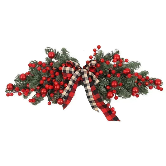 Decorative Christmas swag with red berries and plaid ribbons on a white background