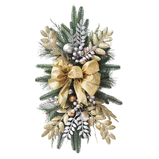 Decorative wreath with gold bow, greenery, and berries on a textured white wall.