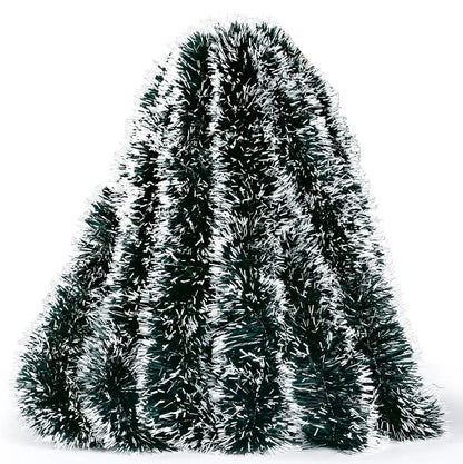 Decorative tinsel tree with a hand holding it on a white background