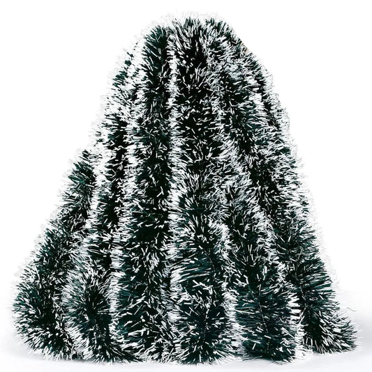 Decorative tinsel tree with a hand holding it on a white background