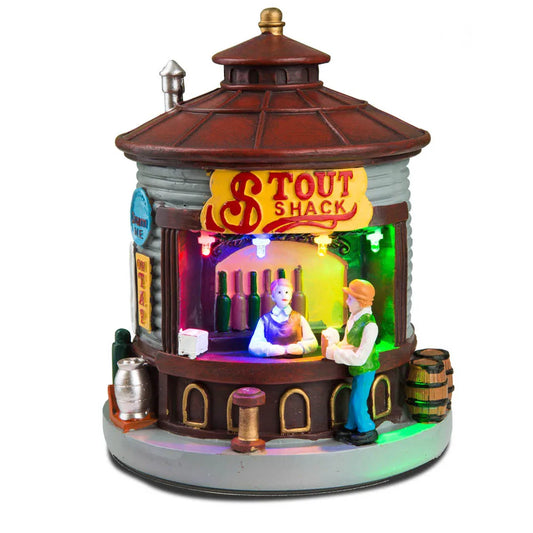 Decorative model of a shack with colorful interior and 'Tout Shack' sign on a white background
