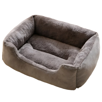 Gray pet bed on a fluffy white carpet