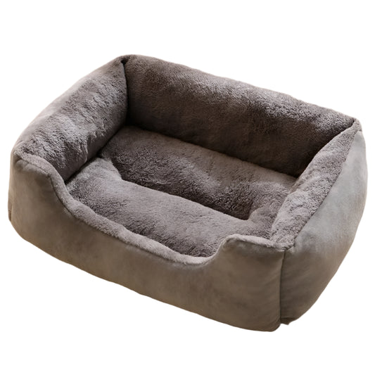 Gray pet bed on a fluffy white carpet